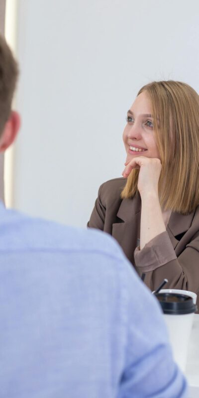Smiling businesswoman engaged in a positive meeting with colleague.
